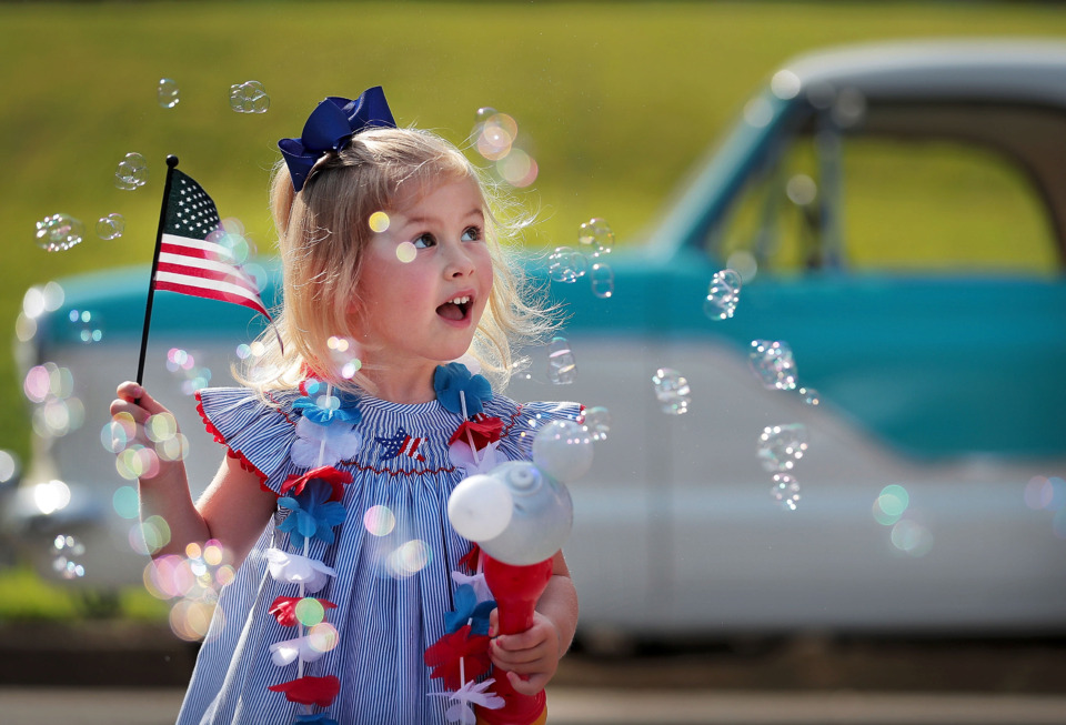 <strong>Four-year-old Lily Priestley makes her own cloud of bubbles before the start of the 70th annual Independence Day Parade in the High Point Terrace neighborhood on July 4, 2019.</strong> (Jim Weber/Daily Memphian)