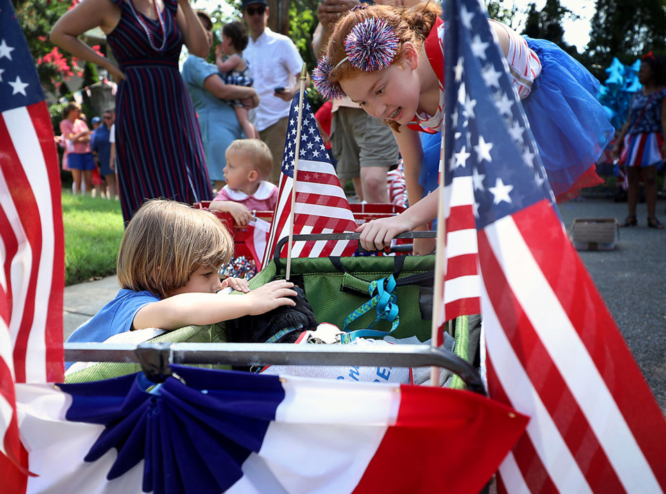 <strong>Ginger the dog soaks up the attention from Wake Gordon as Izzie Cochran looks on Thursday, July 4, 2019.</strong> (Patrick Lantrip/Daily Memphian)
