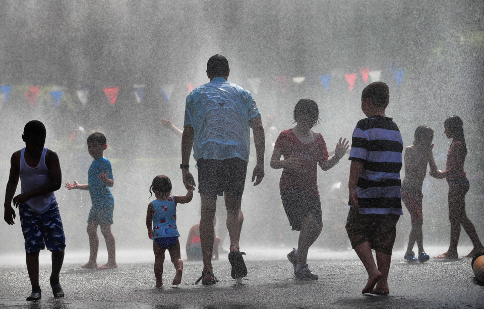 <strong>A crowd of kids dance in the spray of the fire hose after the 70th annual Independence Day Parade in the High Point Terrace neighborhood on July 4, 2019. Once again East Memphis residents gathered for a patriotic morning of star-spangled bikes, waving neighbors and a dousing by the Memphis Fire Department.</strong> (Jim Weber/Daily Memphian)