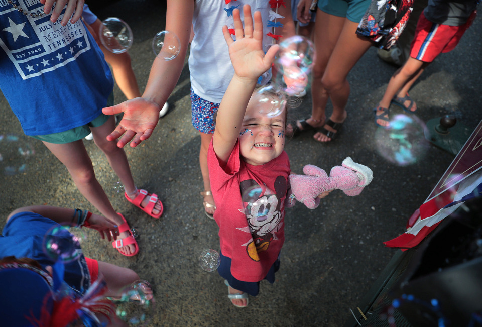 <strong>Scarlet Pentecost, 3, pops clouds of bubbles from one of the floats at the 70th annual Independence Day Parade in the High Point Terrace neighborhood on July 4, 2019. Once again East Memphis residents gathered for a patriotic morning of star-spangled bikes, waving neighbors and a dousing by the Memphis Fire Department.</strong> (Jim Weber/Daily Memphian)