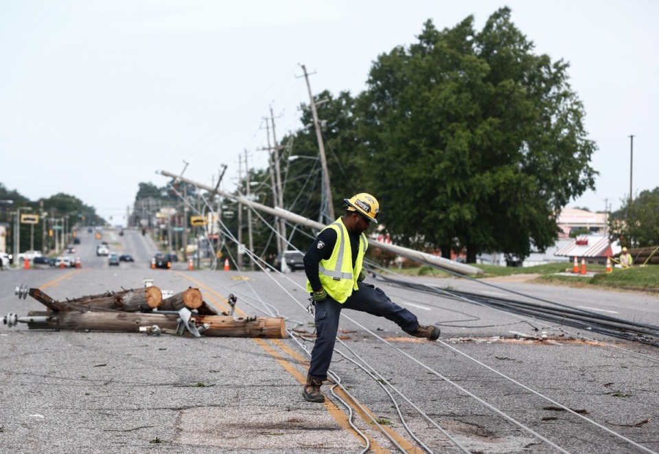 <strong>Memphis Light, Gas and Water crews work to restore power to several downed electrical lines on Winchester Road near Ross Road on Wednesday, July 19, 2023.&nbsp;Two separate vehicles hit MLGW utility poles on Christmas Day, causing two minor but hourslong power outages.&nbsp;</strong>(Mark Weber/The Daily Memphian file)