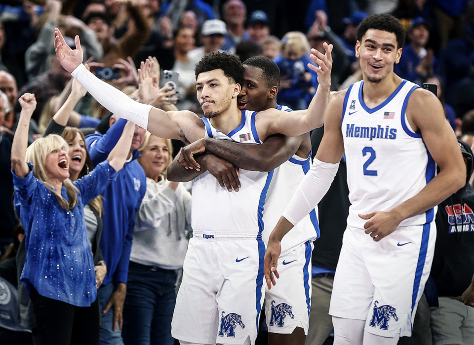 <strong>Memphis guard Jahvon Quinerly (middle) celebrates after hitting a game-winning 3-point shot against SMU on Sunday, Jan. 7.</strong> (Mark Weber/The Daily Memphian)