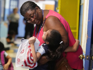 <strong>A teacher at Our Lady of Sorrows in Frayser says goodbye to one of her students on the last day of school this year. The Jubilee Schools in Memphis closed at the end of May, with many of the schools reopening as charter schools.</strong> (Karen Pulfer Focht/Special to The Daily Memphian)