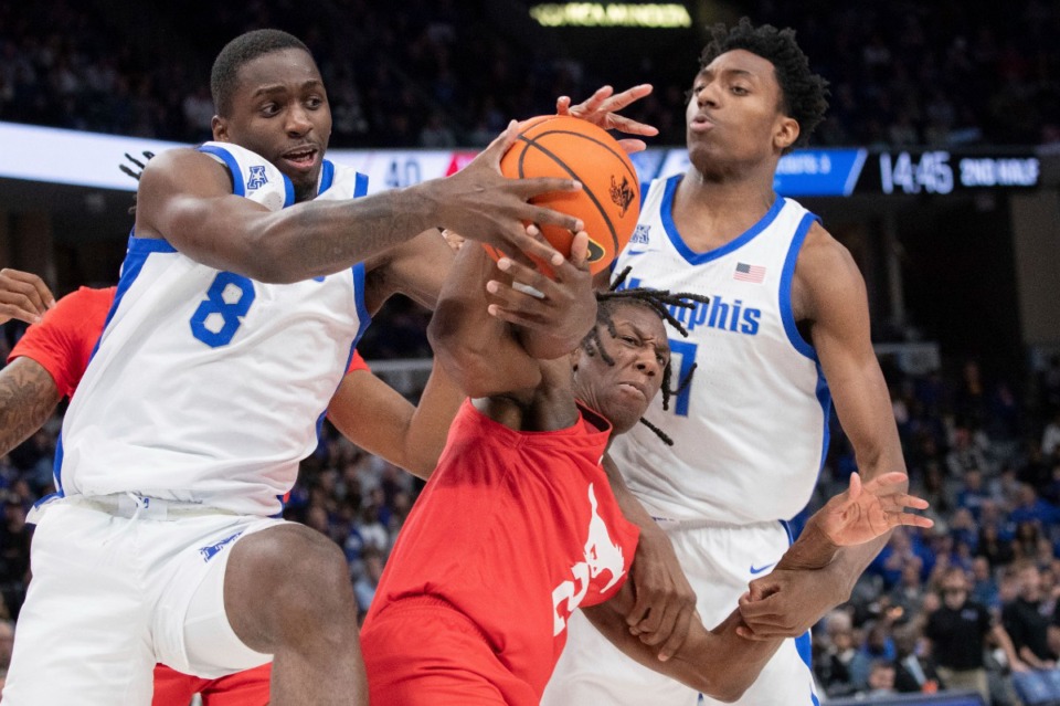 <strong>Memphis forward David Jones (8) pressures SMU guard Jalen Smith (2) for the ball with help from Memphis forward Nae'Qwan Tomlin (7) during the second half of an NCAA college basketball game Sunday, Jan. 7, 2024, in Memphis.</strong> (Nikki Boertman/AP Photo)