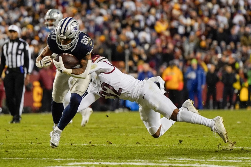 <strong>Dallas Cowboys running back Tony Pollard (20) carries the ball against Washington Commanders safety Terrell Burgess (32) during the first half of an NFL football game Jan. 7 in Landover, Md.</strong> (Jessica Rapfogel/AP file)