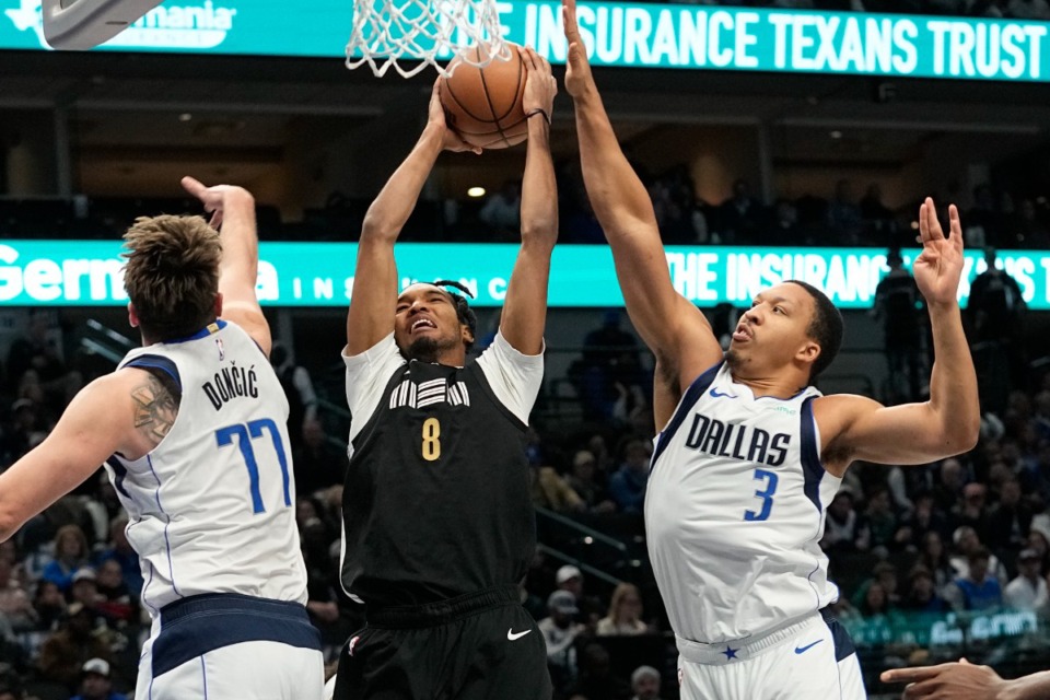 <strong>Memphis Grizzlies forward Ziaire Williams (8) goes to the basket against Dallas Mavericks defenders Luka Doncic (77) and Grant Williams (3) in Dallas, Tuesday, Jan. 9, 2024.</strong> (LM Otero/AP)