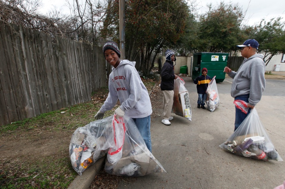 <strong>From left: J.R. Upton, James Houston, Jeremy Upton and Deon Crum of St. George's Independent School clean up litter and debris along Broad Avenue.</strong> (The Daily Memphian file)