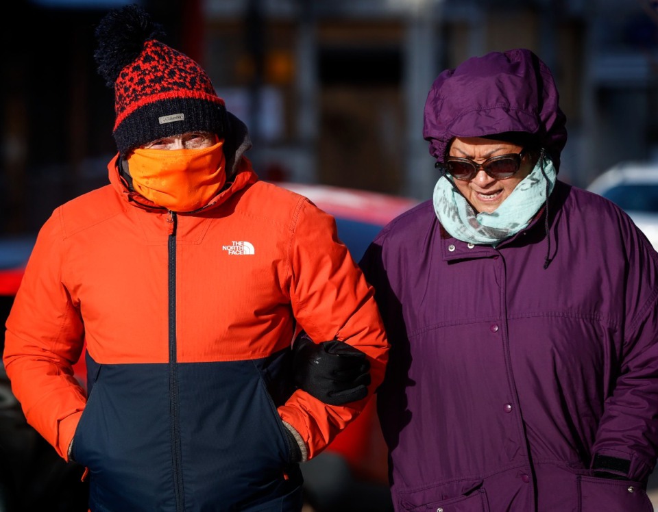 <strong>Thelma and Kevin Worrall, from England, brave the blistering cold temperatures and icy conditions while taking a stroll downtown on Friday, Dec. 23, 2022.</strong> (Mark Weber/The Daily Memphian file)