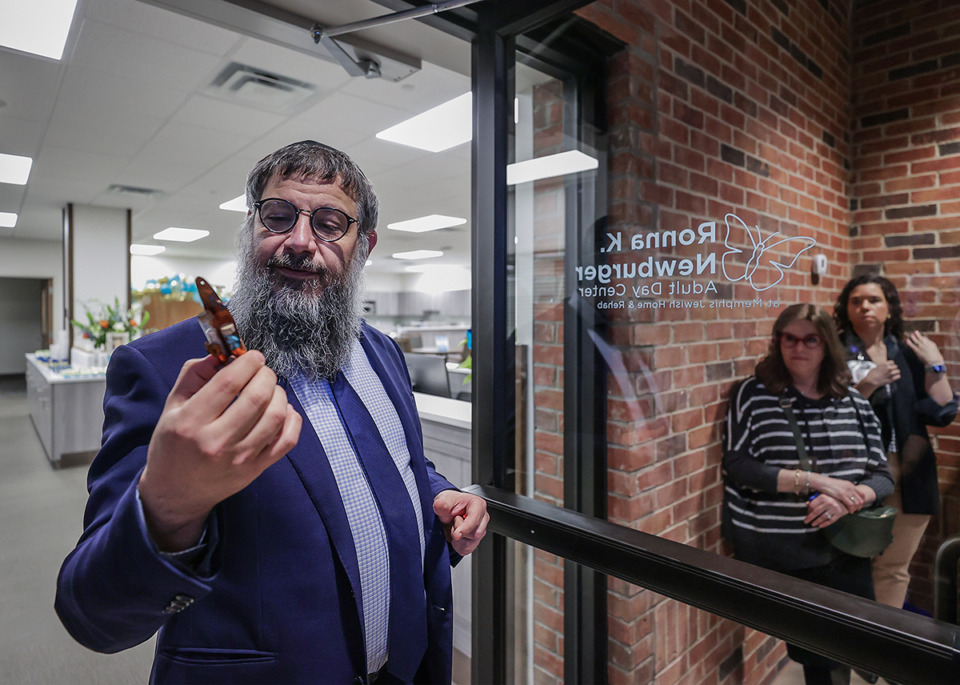 <strong>Rabbi Levi Klein gets ready to affix a traditional Mezzuza to the entrance of the newly-christened Ronna K. Newburger Adult Day Center at the Memphis Jewish Home &amp; Rehab Jan. 11, 2023.</strong> (Patrick Lantrip/The Daily Memphian)