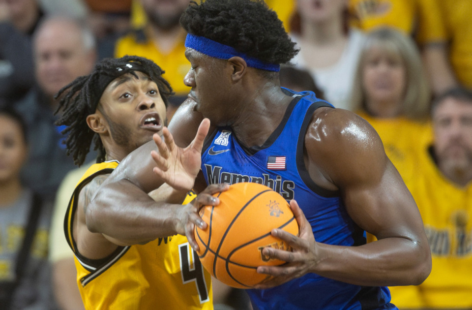 <strong>Wichita State's Colby Rogers, left, commits a foul against Memphis' Malcolm Dandridge during the first half of an NCAA college basketball game, Sunday, Jan. 14, 2024, in Wichita, Kan.</strong> (Travis Heying/The Wichita Eagle via AP)