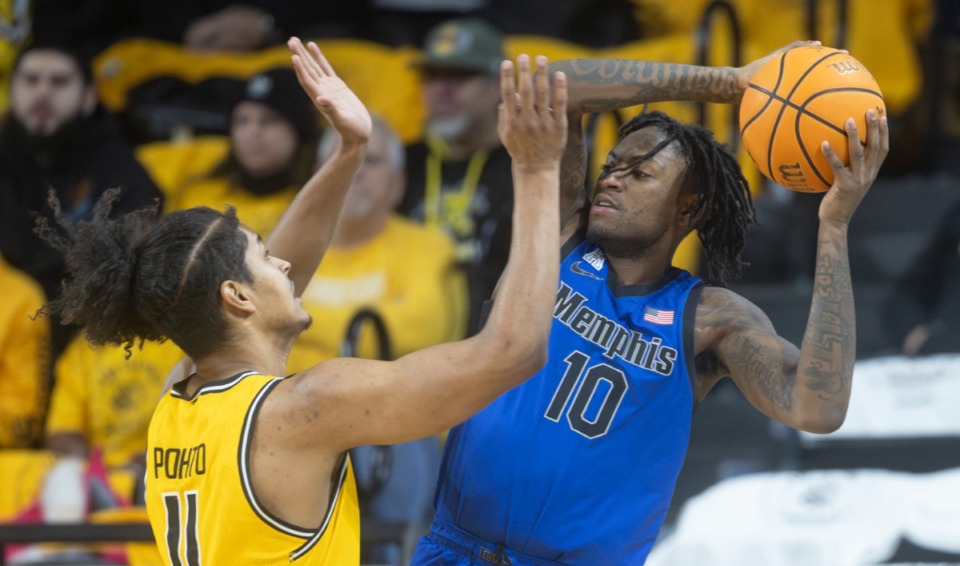 <strong>Memphis' Jaykwon Walton looks for a pass against Wichita State defender Kenny Pohto during the first half of an NCAA college basketball game, Sunday, Jan. 14, 2024, in Wichita, Kan.</strong> (Travis Heying/The Wichita Eagle via AP)