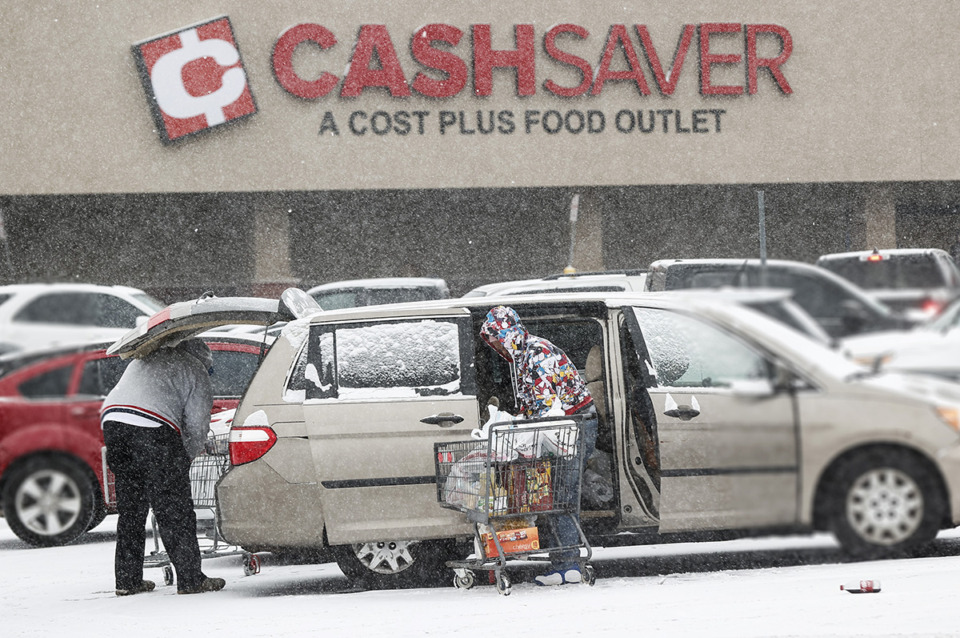 <strong>Cash Saver customers grab last minute items as snow falls on Sunday, January 14.</strong> (Mark Weber/The Daily Memphian)