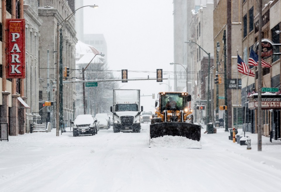 <strong>Ploughs clear streets in Downtown Memphis as snow falls on Monday, Jan. 15, 2024.</strong> (Mark Weber/The Daily Memphian)