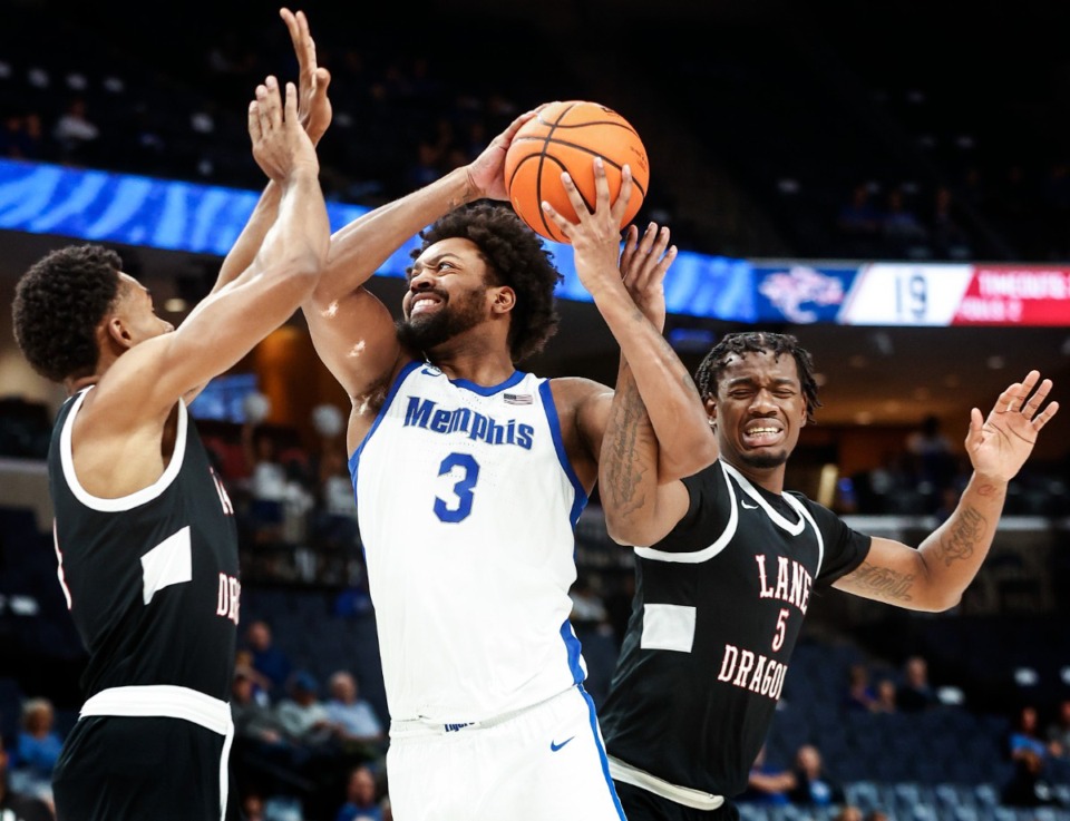 <strong>University of Memphis center Jordan Brown drives the lane against Lane College defenders Floyd Williams (left) and Darell Johnson (right) during action on Sunday, Oct.29, 2023.</strong> (Mark Weber/The Daily Memphian file)