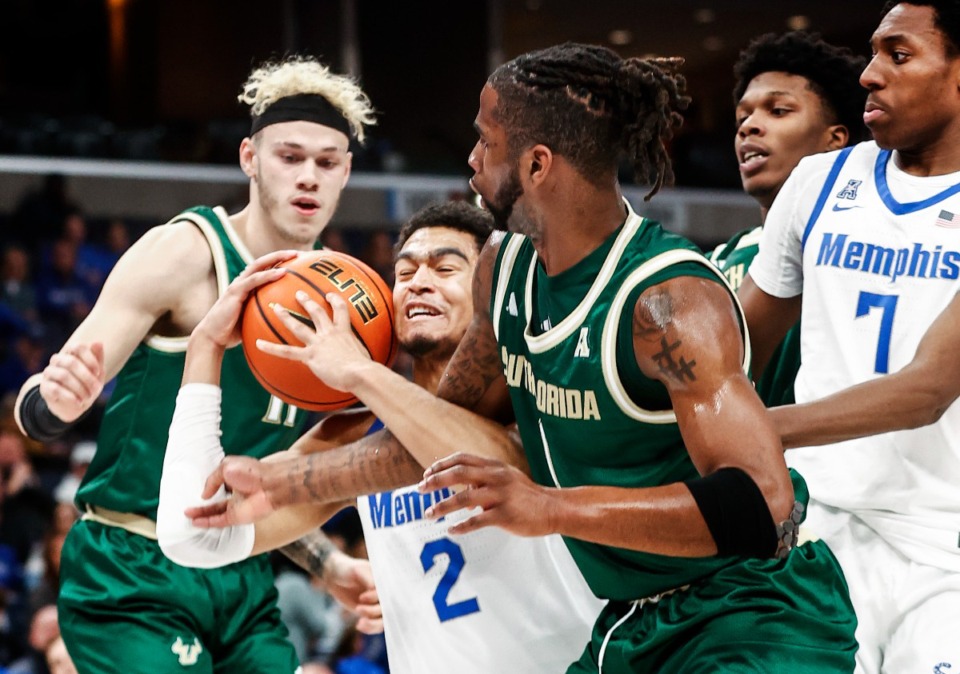 <strong>University of Memphis forward Nicholas Jourdain (middle) fights for a rebound against the University of South Florida on Thursday, Jan. 18, 2024.</strong> (Mark Weber/The Daily Memphian)