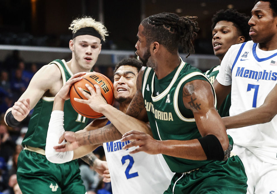 <strong>University of Memphis forward Nicholas Jourdain, middle, fights for a rebound against the University of South Florida during action Jan. 18.</strong> (Mark Weber/The Daily Memphian)