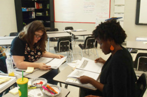 <strong>Middle school social studies teachers Zan Brennan and Chloe Smuk discuss the new state standards during their lunch break at a teacher training held in June at Arlington High School. </strong>(Kathryn Palmer/ Chalkbeat)