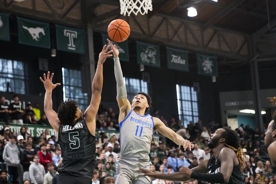 <strong>Memphis guard Jahvon Quinerly (11) shoots against Tulane forward Collin Holloway (5) during an NCAA college basketball game in New Orleans, Sunday, Jan. 21, 2024.</strong> (Gerald Herbert/AP Photo)