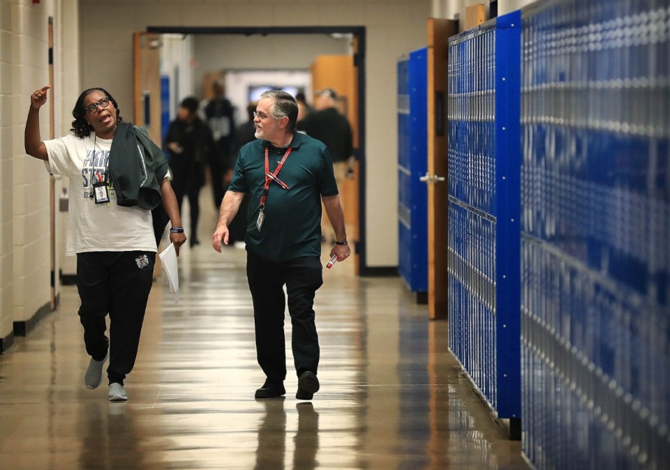 <strong>Kirby High School teachers Michelle Taylor (left) and Raymond Caldwell prepare for reopening after a rat infestation forced Memphis-Shelby County Schools to close the high school for four months in 2018. The school closed early on Jan. 23, 2024 due to a burst water pipe.</strong> (Daily Memphian file)