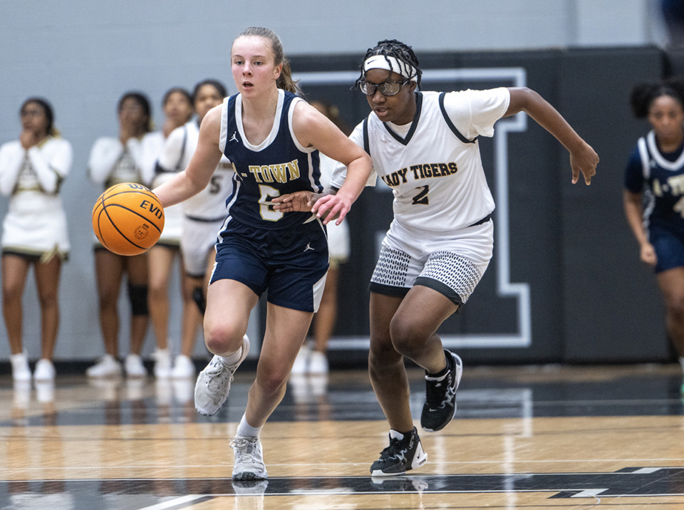 <strong>Arlington's Taylor Miller pushes the ball up the court with Whitehaven's Jalaiya Williams closely guarding her in the Region 8 Class 4A semi-finals Feb 27, 2023, at Houston High School.</strong> (Greg Campbell/Special for The Daily Memphian file)
