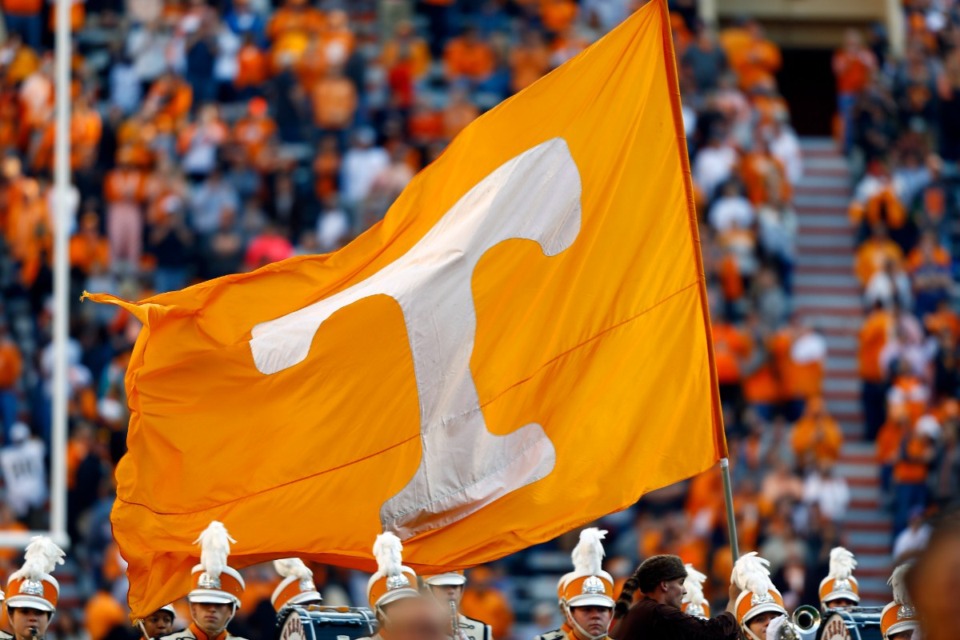 <strong>A Tennessee cheerleader runs with a flag before an NCAA college football game against Vanderbilt Saturday, Nov. 25, 2017, in Knoxville, Tenn. Tennessee has been in contact with NCAA investigators and a person with direct knowledge of the situation told The Associated Press on Tuesday, Jan. 30, 2024, the inquiry is into potential rules violations related to name, image and likeness compensation for multiple athletes.</strong> (AP Photo/Wade Payne, File)