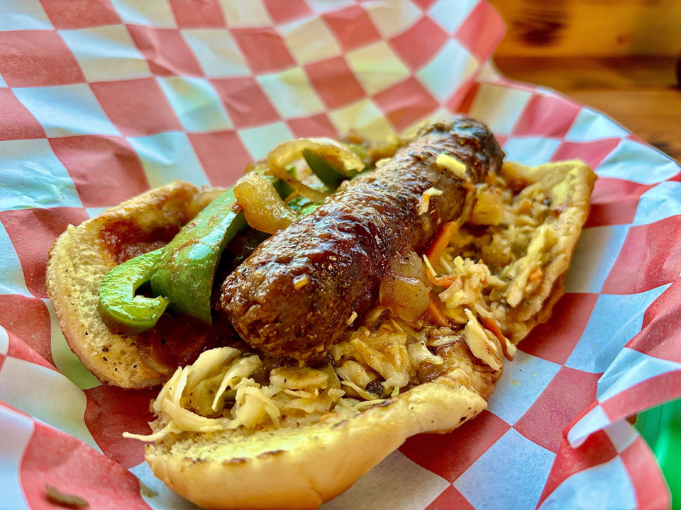 <strong>The Italian smoked sausage sandwich at Plant Based Heat includes a vegan sausage in a hot dog bun smothered in sweet barbecue sauce and vegan coleslaw.</strong> (Joshua Carlucci/Special to The Daily Memphian)