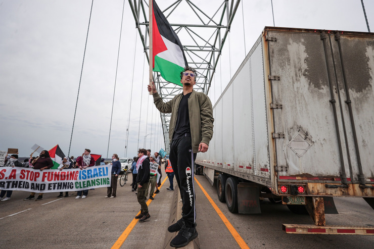<strong>Abdallah, who only agreed to give his first name, holds a Palestinian flag in the median of the Interstate 40 bridge that spans the Mississippi River between Arkansas and Tennessee during a protest that shut down traffic on the bridge Feb. 3.</strong> (Patrick Lantrip/The Daily Memphian)