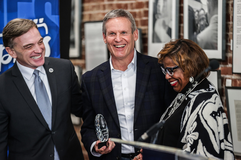 <strong>Tennessee Governor Bill Lee (center) hands Rosalind Withers (right) a plaque enshrining the Withers Collection Museum and Gallery on Beale Street as an official part of National Civil Rights Trail Feb. 6.</strong> (Patrick Lantrip/The Daily Memphian)
