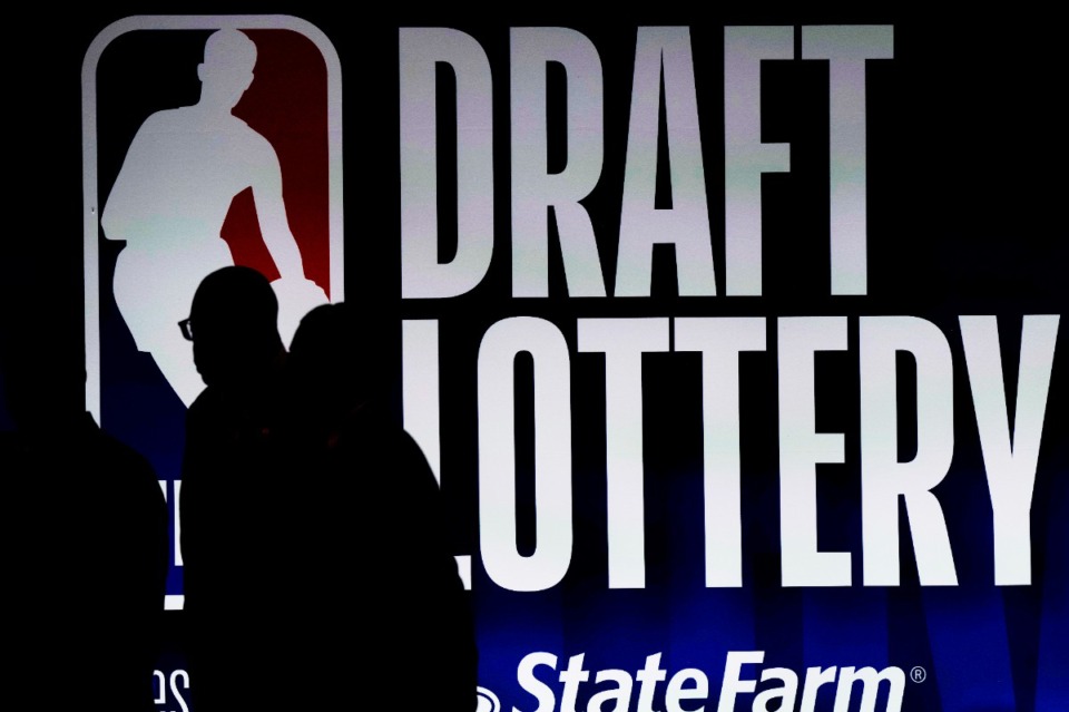<strong>People walk by a sign during the NBA basketball draft lottery in Chicago, Tuesday, May 16, 2023.</strong> (AP Photo/Nam Y. Huh)