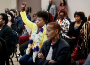 <strong>Tikeila Rucker (middle) celebrates during the vote for superintendent during the Memphis-Shelby County Schools board meeting Feb. 8, 2024.</strong> (Mark Weber/The Daily Memphian)