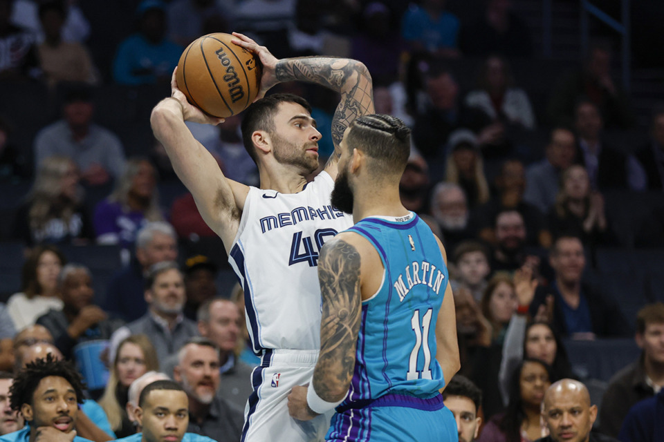 <strong>Memphis Grizzlies guard John Konchar, left, looks to pass against Charlotte Hornets forward Cody Martin during the first half of an NBA basketball game in Charlotte, N.C., Feb. 10.</strong> (Nell Redmond/AP file)