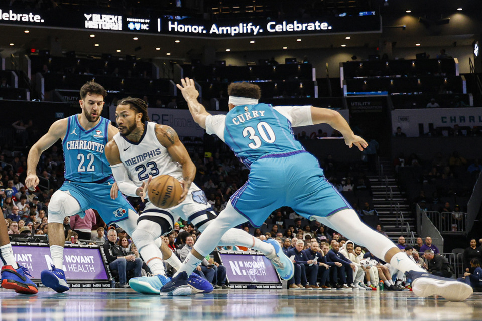 <strong>Memphis Grizzlies guard Derrick Rose (23) drives between Charlotte Hornets guards Vasilije Micic, left, and Seth Curry, right, during the first half of an NBA basketball game in Charlotte, N.C., Saturday, Feb. 10.</strong> (Nell Redmond/AP file)