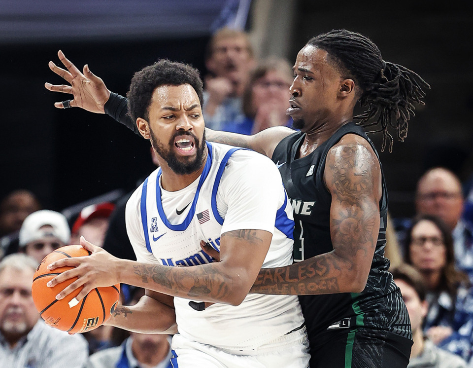 <strong>Memphis center Jordan Brown, left, drives the lane against Tulane University defender Kevin Cross, right, during action on Sunday, Feb. 11, 2024.</strong> <strong>Brown contributed 7 points and 3 rebounds in 16 minutes of action.</strong> (Mark Weber/The Daily Memphian)
