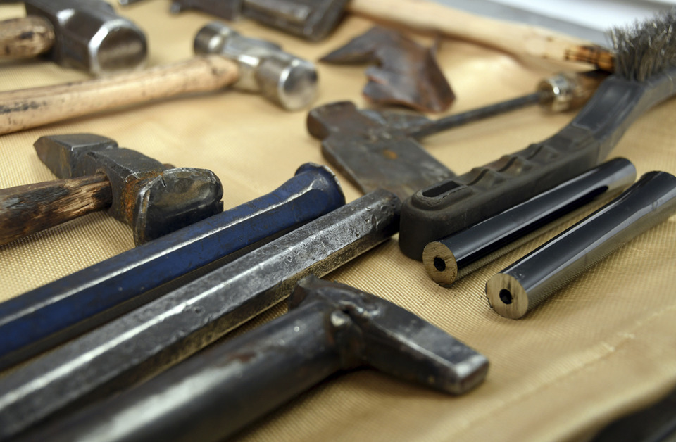 <strong>Evergreen Presbyterian Church will host Guns to Gardens, a one-day safe surrender event where unwanted guns will be dismantled to be transformed into garden tools. Sections of a rifle barrel, right, sit next to blacksmithing tools on a table at a 2022 Guns to Gardens event at a church in Denver.</strong> (Thomas Peipert/AP Photo file)