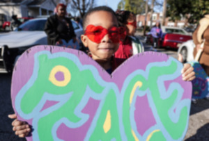 <strong>Adam Holton holds up his wooden heart at the Carpenter Art Garden in Binghampton before a protest to raise awareness about gun violence on Feb. 13, 2024.</strong> (Patrick Lantrip/The Daily Memphian)