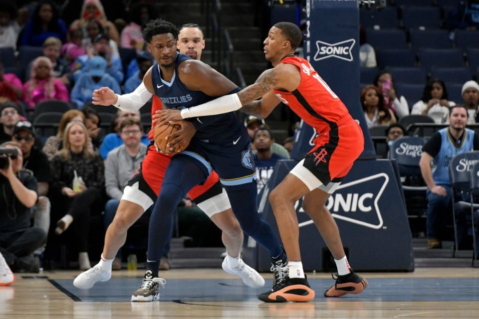 <strong>Memphis Grizzlies forward Jaren Jackson Jr. protects the ball from Houston Rockets forward Jabari Smith Jr., right, as forward Dillon Brooks defends on Wednesday, Feb. 14, 2024.</strong> (Brandon Dill/AP)