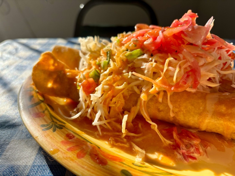 <strong>The tacos dorados at Rincon Catracho are a pair of flour tortillas stuffed with cheese and shredded chicken and fried into a long cylindrical flute, draped in cabbage and pickled onions. </strong>(Joshua Carlucci/Special to The Daily Memphian)