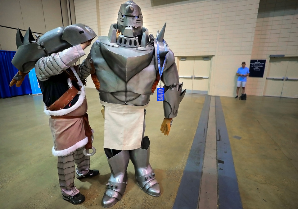 <strong>John Herbold of Little Rock reattaches an arm to daughter Meagan Herbold's 7-foot Alphonse Elric costume as anime enthusiasts gear up for the first day of Anime Blues Con 9 at the Memphis Convention Center on Friday, July 12.&nbsp;<span>&ldquo;There&rsquo;s two video cameras inside and an LCD panel mounted on the inside. That&rsquo;s how she sees,&rdquo; John Herbold said.&nbsp;</span></strong>(Jim Weber/Daily Memphian)