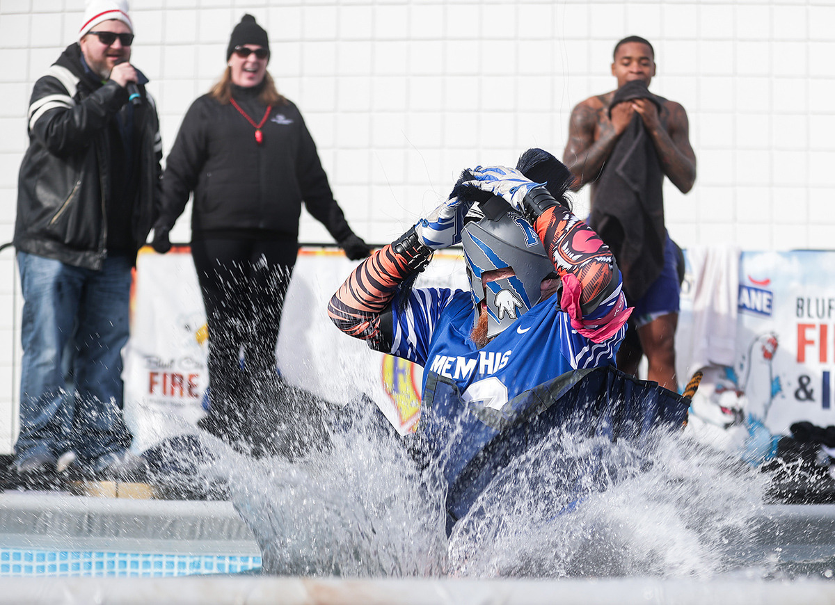 <strong>Longtime Tigers fan Phil Glass takes a dive in his gameday attire during the 17th annual Chili Cook-off and 26th annual Polar Bear Plunge Feb. 17.</strong> (Patrick Lantrip/The Daily Memphian)