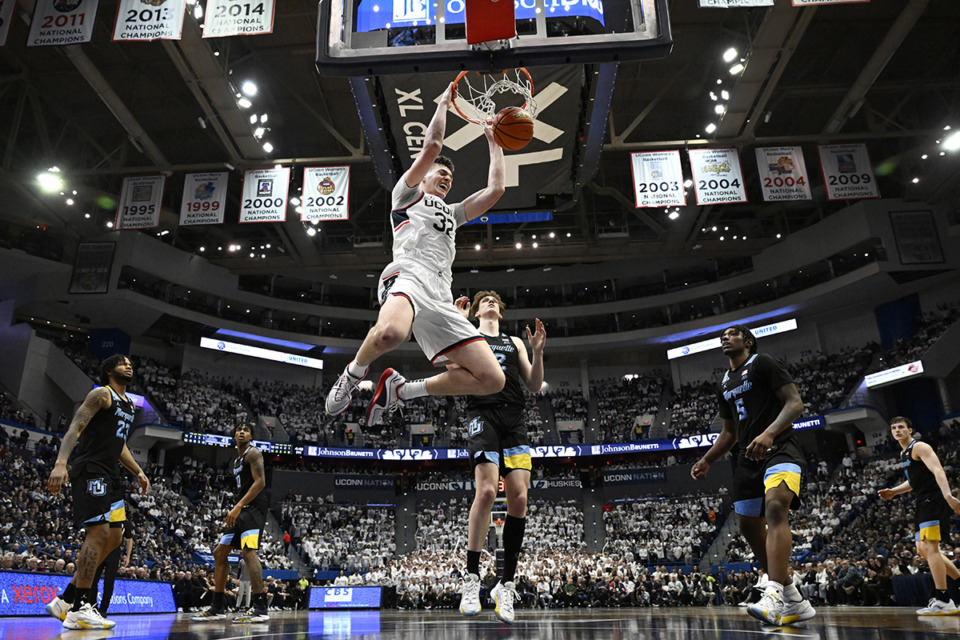 <strong>UConn center Donovan Clingan (32) dunks the ball in the second half of an NCAA college basketball game against Marquette Feb. 17, 2024, in Hartford, Conn.</strong> (Jessica Hill/AP Photo)