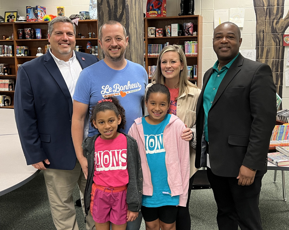 <strong>Tennessee Principal Association&rsquo;s Brian Partin (left) and Terrence Brittenum (right) join Tyler Salyer's family in the Sycamore Elementary library on April 13, 2023, when Salyer was name a National Distinguished Principal for 2023.</strong> (Courtesy Collierville Schools)