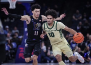 <strong>University of Memphis guard Jahvon Quinerly (11) takes a charge from Charlotte guard Nik Graves (10) during the Feb. 21, 2024, game.</strong> <strong>Quinerly had 17 points and 6 assists in the Tigers, 76-52, win. </strong>(Patrick Lantrip/The Daily Memphian)