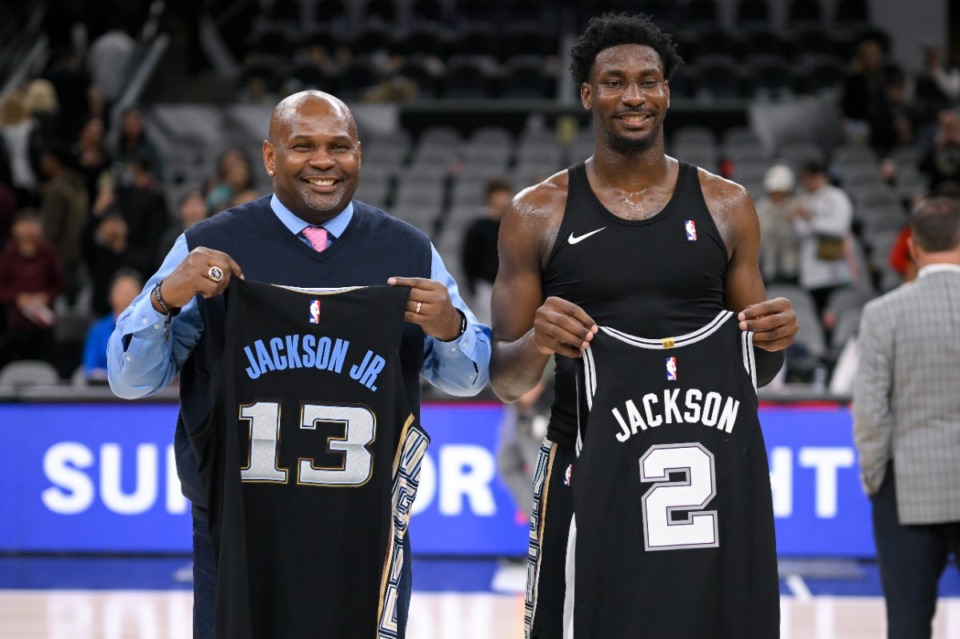 <strong>Memphis Grizzlies' Jaren Jackson Jr., right, and his father, former NBA player Jaren Jackson Sr., trade jerseys and pose for photos after an NBA basketball game against the San Antonio Spurs, Friday, March 17, 2023, in San Antonio. Memphis won 126-120 in overtime.</strong> (AP Photo/Darren Abate)