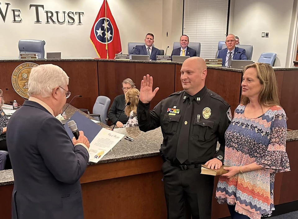 <strong>Bartlett Police Department Captain Todd Halford stands with his wife, Rachel, as he is sworn in by Mayor David Parsons as the city's new chief communications officer on Tuesday, Feb. 27, 2024, at Bartlett City Hall.</strong> (Michael Waddell/The Daily Memphian)