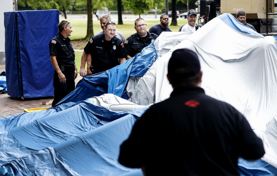 <strong>Members of the Memphis Fire Department help set up three inflatable field hospitals that can spring to life in seven minutes and hold roughly 20 beds each, in Robert Church Park Tuesday, July 16. Memphis Office of Emergency Management will have tours of the brand-new tent city from 10 a.m. to 4 p.m. on Wednesday.</strong> (Mark Weber/Daily Memphian)