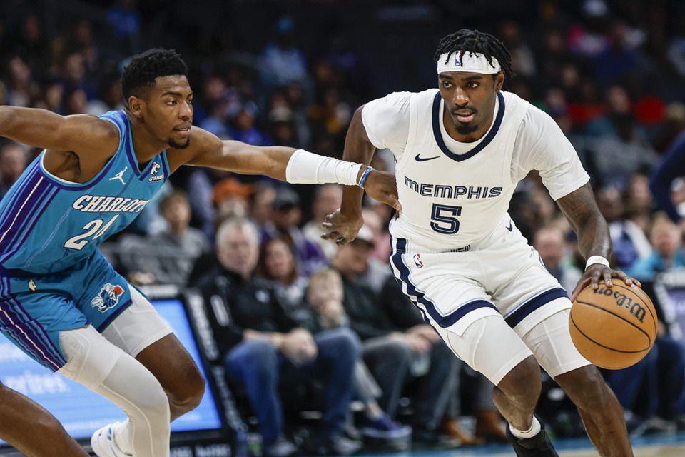 <strong>Memphis Grizzlies guard Vince Williams Jr. (5) drives past Charlotte Hornets forward Brandon Miller during a game in Charlotte, N.C., Saturday, Feb. 10, 2024.</strong> (Nell Redmond/AP Photo file)