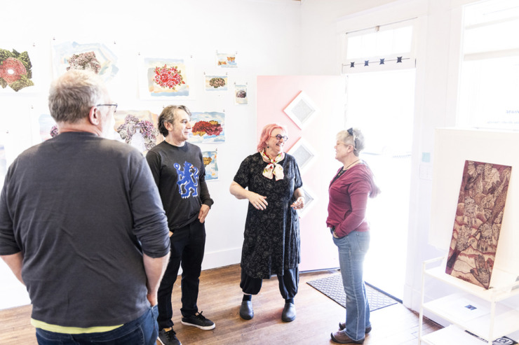 <strong>Keiko Gonzalez (center left) and Mary Jo Karimnia (center right) attend the Studiohouse on Malvern open house.</strong> (Brad Vest/Special to The Daily Memphian)