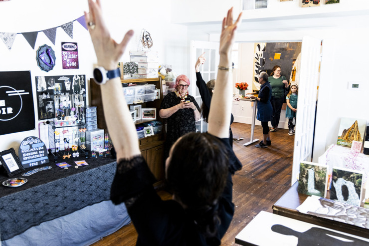 <strong>Mary Jo Karimnia, center, takes a video during the Pizza Witches dance ceremony at Studiohouse on Malvern during their second open house.</strong> (Brad Vest/Special to The Daily Memphian)
