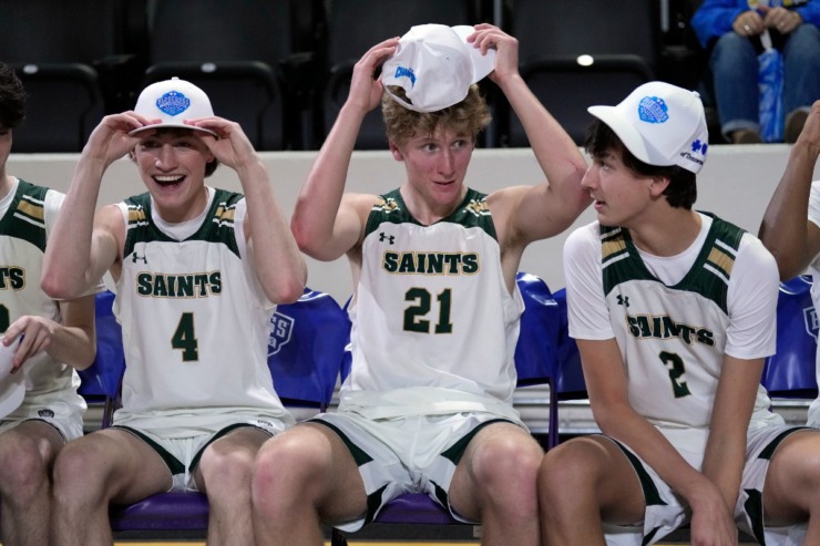 <strong>Briarcrest Christian players Grayson Farmer (4), Braden Bryan (21), and Parker Pounds (2) put on their championship caps after defeating Brentwood Academy in the Division II-AA championship basketball game Saturday, March 2, 2024, in Cookeville, Tenn.</strong> (Mark Humphrey/Special to The Daily Memphian)