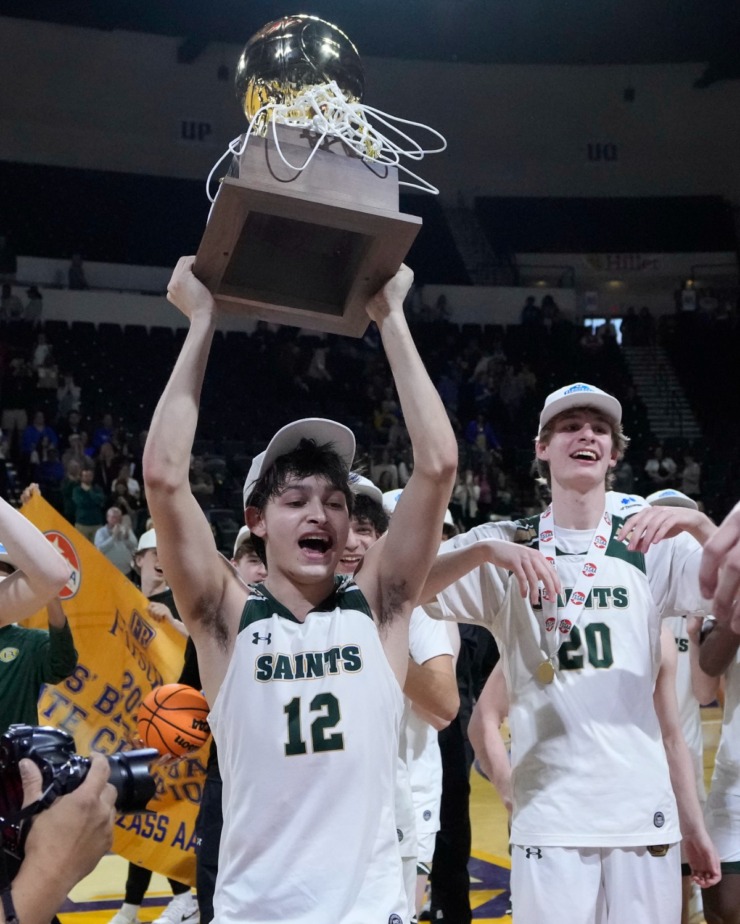 <strong>Briarcrest Christian guard Connor Mancell (12) holds the trophy after defeating Brentwood Academy in the Division II-AA championship basketball game Saturday, March 2, 2024, in Cookeville, Tenn.</strong> (Mark Humphrey/Special to The Daily Memphian)